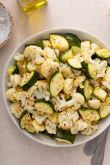 Roasted cauliflower and zucchini with garlic and herbs in a serving bowl