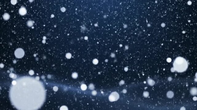 Slow motion video of snowflakes falling against a dark blue background creating a serene winter atmosphere with varying snowflake sizes and soft lighting