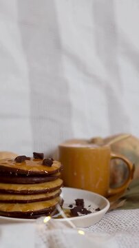 Chocolate Shavings Falling onto a Stack of Honey Glazed Cookies