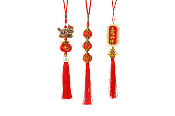 Naklejka premium Three traditional red decorations hanging with tassels, isolated, PNG