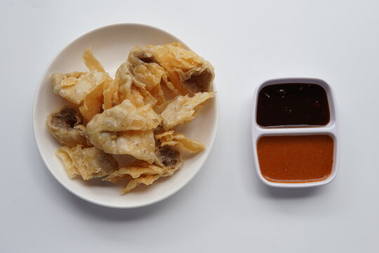 Crispy Batagor with Dipping Sauce. This traditional Asian snack is perfectly golden and crunchy, making it a popular appetizer.