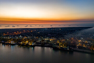 Obraz premium Aerial View of Chittagong Port and Karnaphuli River at Twilight. Busy Container Terminal and Cargo Ships at Chattogram Sea Port, Bangladesh. 
