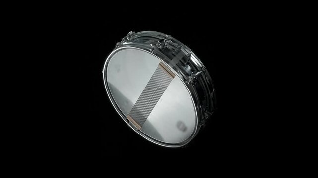 Snare drum rotates smoothly on a black background in a clean studio-style product shot