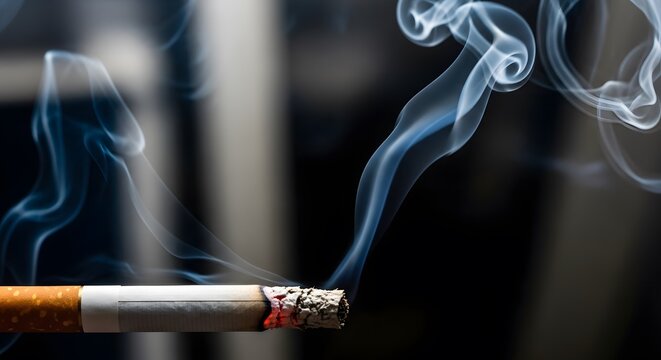 A cigarette with smoke rising against a dark background
