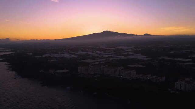 Panoramic drone shot of a hotels on the coastline of Jeju island, dusk in Korea