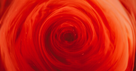 Paint vortex. Orange swirl vapor. Defocused bright red color glitter acrylic fume smoke round texture twirl on abstract light background.