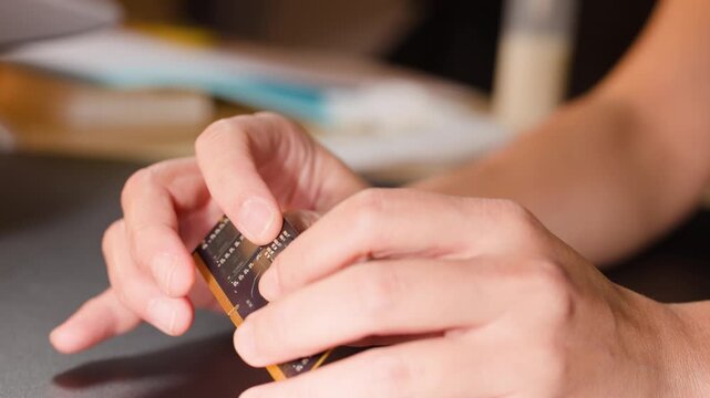 Close Up of Hands Bending a Flexible Printed Circuit Board