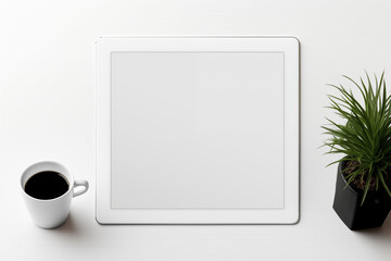 A simple, flat desk with an empty screen and related equipment.