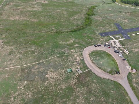 Aerial view of model RC aircraft runway, surrounded by plush greenery, Colorado