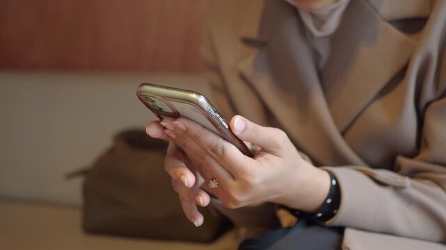 Person using a smartphone in a cafe on a weekday