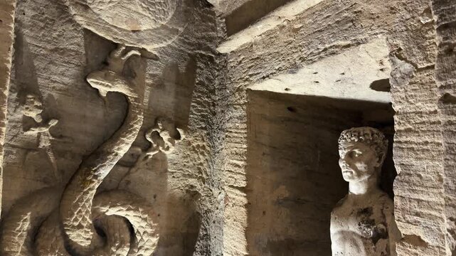 Serpent relief and carved figure inside the Catacombs of Kom el Shoqafa