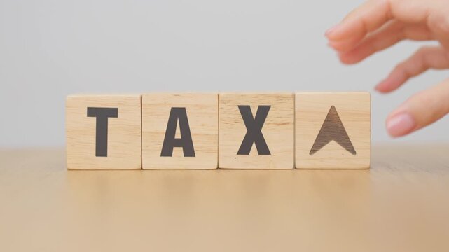 hand change wooden block with TAX text to UP and Down arrow icon. decrease and Increase, Taxpayer, Taxable Income, Tax Filing, Deduction, Withholding Tax, WHT, VAT, Computation and Exemption concept