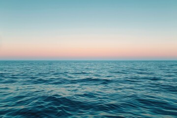 Obraz premium Calm Ocean Water Under Clear Sky at Sunset.