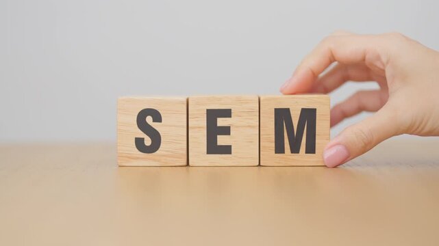 Hand change Wooden block from SEO to SEM. Search Engine Optimization, SEA, Advertising, Marketing, Idea, Strategy, Keyword, Content and technology concept
