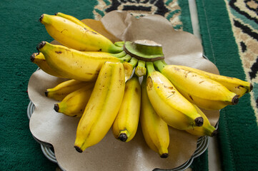Fresh bunches of ripe yellow bananas hanging in a local market © IMAZA Photo