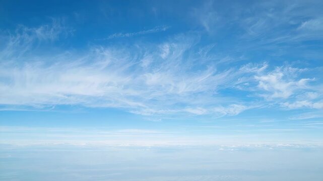 Blue sky cirrus cloud streaks and layers over soft horizon blue atmosphere calm airy mood