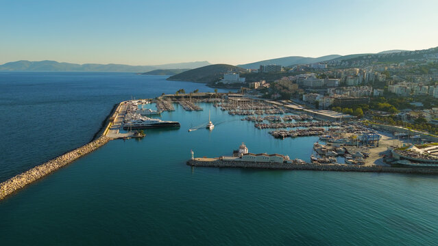Kusadasi, Turkey. Setur Marina with numerous yachts docked in the harbor. Summer morning panoramic shot of the marina with city buildings in background. Aerial View