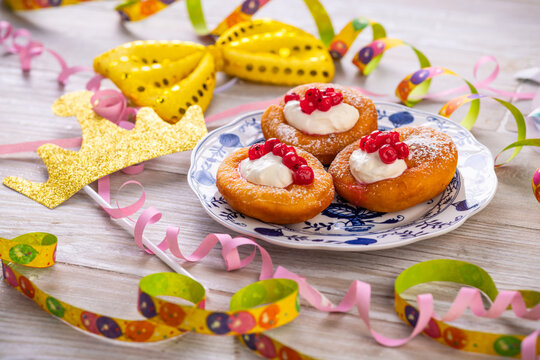 Bavarian donuts with cream and red currants for carnival and fasching