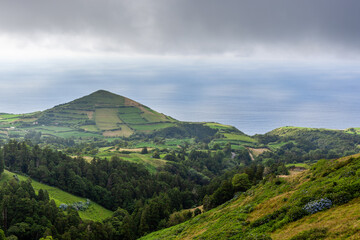 Obraz premium Volcanic landscape on San Miguel Island, Azores. View from Sete Cidades and surrounding mountains. Lush greenery, natural scenery in Portugal.