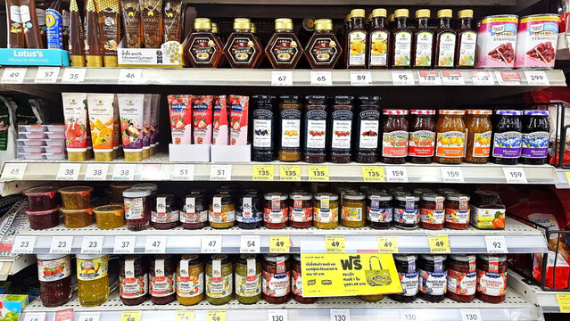 A vibrant display of food products, Jam, honey, spreads on a supermarket shelf, showcasing a colorful assortment of consumer goods, meticulously arranged to entice shoppers. Thailand, February 2, 2026