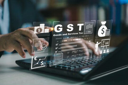 Business professional using digital GST interface for goods and services tax management, showing tax calculation, invoices, compliance reporting, and modern accounting technology on a laptop.
