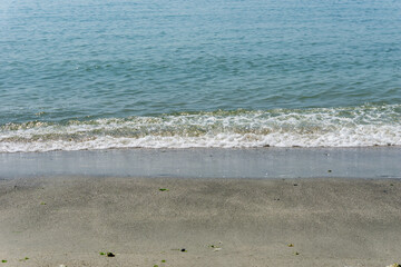 Sand and sea with waves on the beach