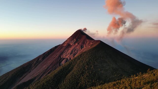 large volcano acatenango erupting in guatemala highlands (famous volcanic hike tourist destination fuego lava smoke) sunrise hiking daybreak geology stunning adventure travel camping antigua getaway