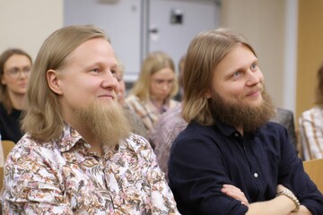 Fototapeta premium Men with beards attending lecture in auditorium