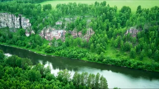 A drone flies over a river. Behol the mesmerizing aerial view of a river meandering through the greenery. Aerial drone view over. Aerial view of a river delta with lush vegetation and winding channels