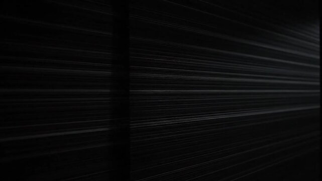 Abstract shot of parallel lines, radiating outwards with a vertical division. Mostly dark hues