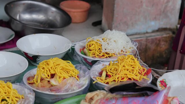 Indonesian street food yellow noodles served in bowls on table with natural light for culinary concept