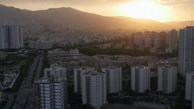 Panoramic Sunset View of Tehran Skyline with Modern Residential Buildings and Alborz Mountains