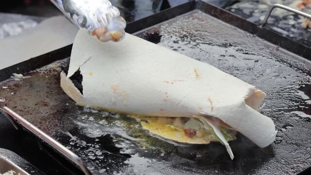 Indonesian street food jajanan leker cooking on flat griddle with natural light for culinary concept
