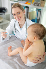 doctor examining little baby in clinic