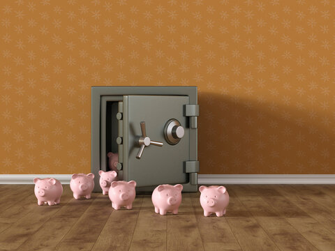 Piggy banks and safe on wood floor representing saving and finance