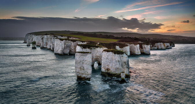 Studland, Dorset, UK - Aerial panoramic view of Old Harry Rocks white cliffs at sunset with dramatic sky. Jurassic coast, Unesco world heritage site, Swanage, Dorset, England, United Kingdom, Europe