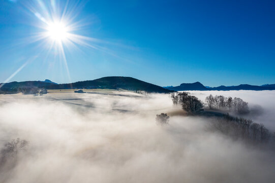 Agricultural landscape with morning fog at sunrise in Upper Austria