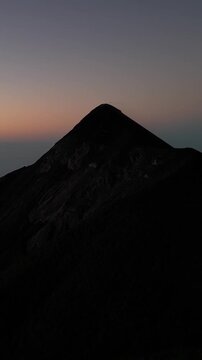 large volcano acatenango erupting in guatemala highlands (famous volcanic hike tourist destination fuego lava smoke) sunrise hiking daybreak geology stunning adventure travel camping antigua getaway