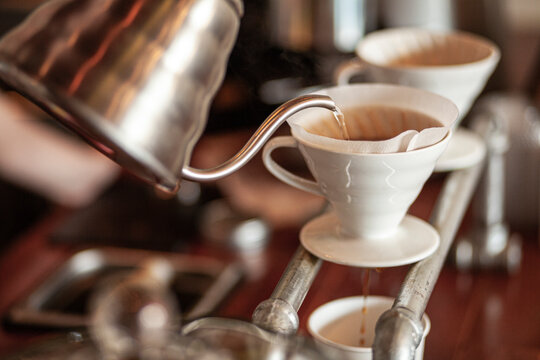 Kettle pouring water over specialty coffee in v60 filter