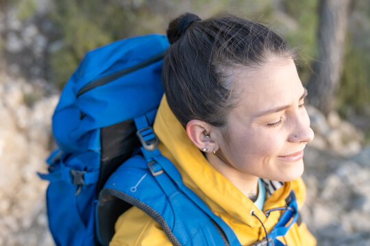 Woman enjoying sun's warmth while hiking outdoors