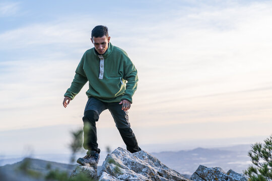 Man exploring mountain peak during outdoor adventure
