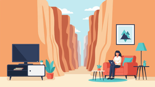 Person working on a laptop on a couch with a canyon view