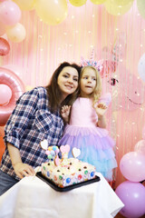 Fototapeta premium Mother and Daughter Celebrating Birthday with Unicorn Theme Party Decorations