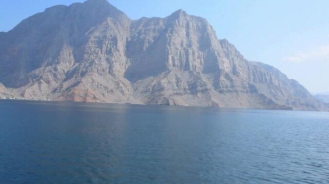 Aerial View of Musandam Peninsula Fjords at the Strategic Strait of Hormuz. overlooking the narrowest point of the Strait of Hormuz. This "Norway of Arabia" serves as the southern gateway to the Persi