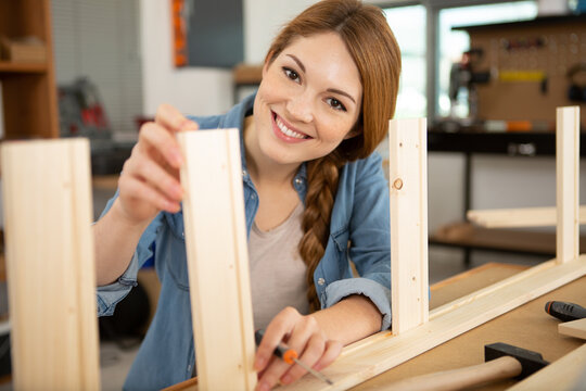 happy woman working with wood