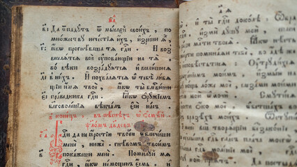 Old Bible book. Close-up of ancient religious text written in ancient Slavic letters, Cyrillic.