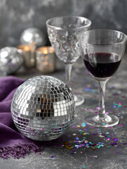 Elegant celebration with disco ball and wine glasses on table