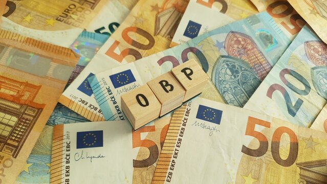 OBP acronym made of wooden letter cubes on pile of Euro banknotes. Ouderdoms- en Bedrijfspensioen (Old Age and Occupational Pension)