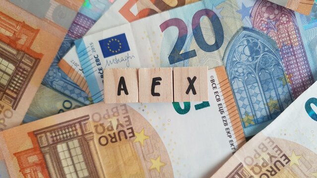 AEX acronym made of wooden letter cubes on pile of Euro banknotes. Amsterdam Exchange Index (Dutch stock market index)