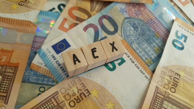 AEX acronym made of wooden letter cubes on pile of Euro banknotes. Amsterdam Exchange Index (Dutch stock market index)